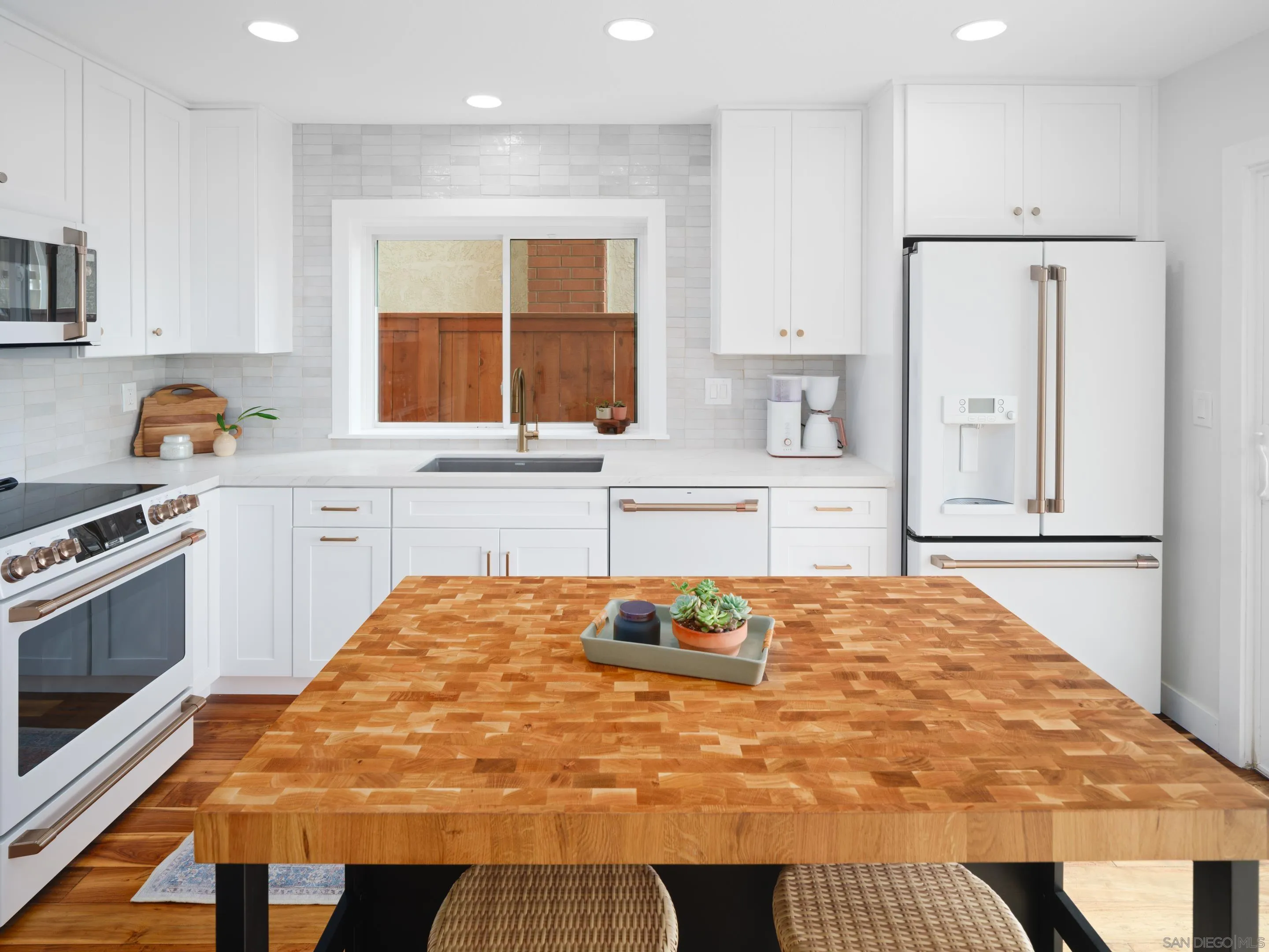 7053 Snapdragon Drive Carlsbad, CA 92011 - Photo 10 of 35 a bedroom with a bed and a large window