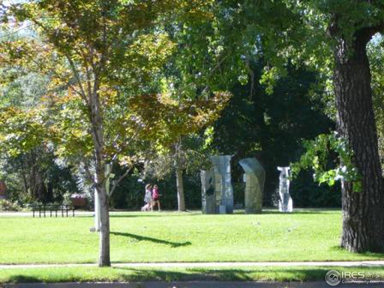 856 Walnut Street, Unit A Boulder, CO 80302 - Photo 11 of 13 a view of a white house with a big yard and large trees