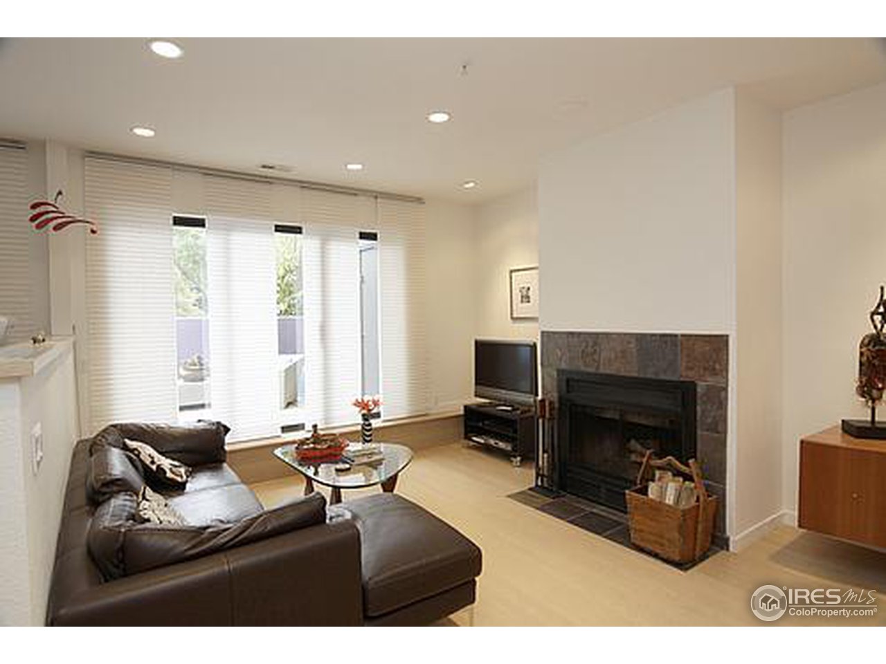 856 Walnut Street, Unit A Boulder, CO 80302 - Photo 4 of 13 a living room with furniture a fireplace and a flat screen tv