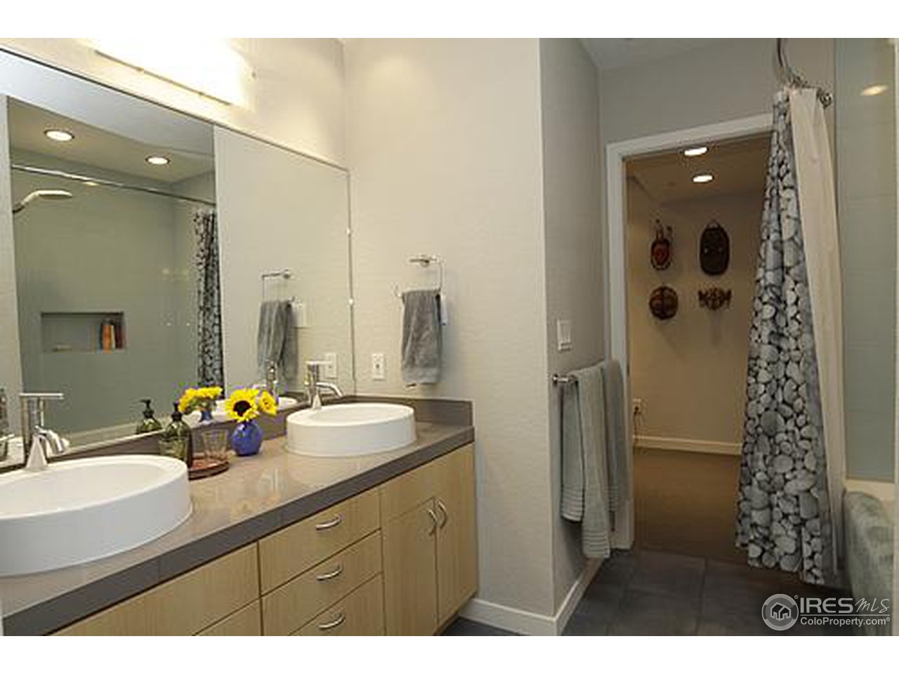 856 Walnut Street, Unit A Boulder, CO 80302 - Photo 6 of 13 a bathroom with a double vanity sink mirror double and shower