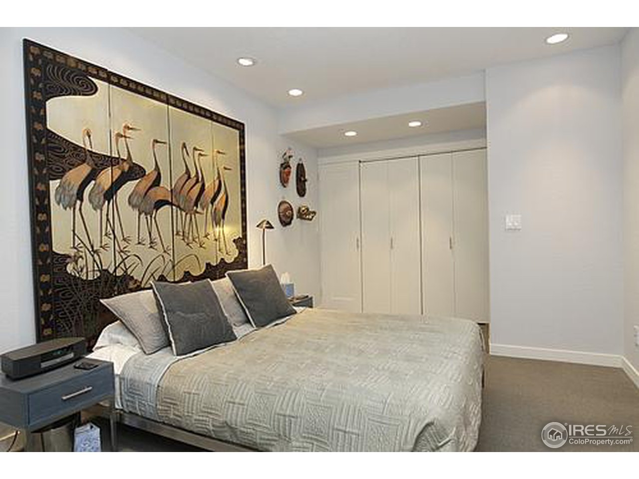 856 Walnut Street, Unit A Boulder, CO 80302 - Photo 7 of 13 a bedroom with a bed and a painting on the wall