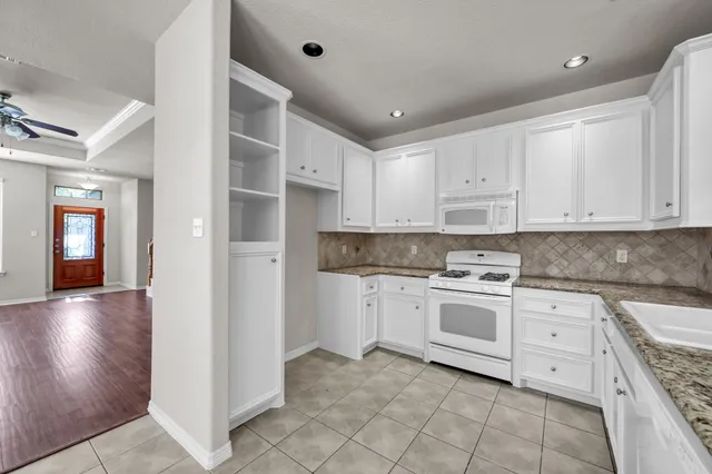 a kitchen with cabinets appliances and a sink