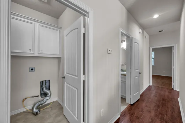 a view of a workspace with wooden floor