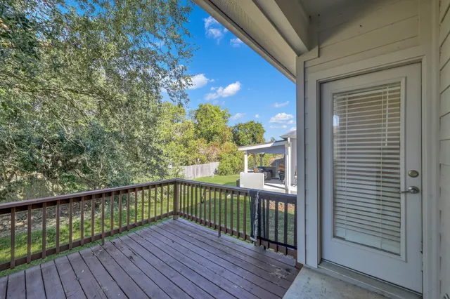 a view of a balcony with wooden floor