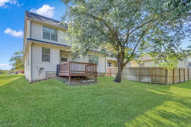 a view of backyard with deck and trees