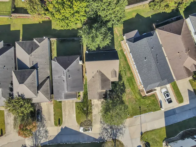 an aerial view of residential houses with outdoor space