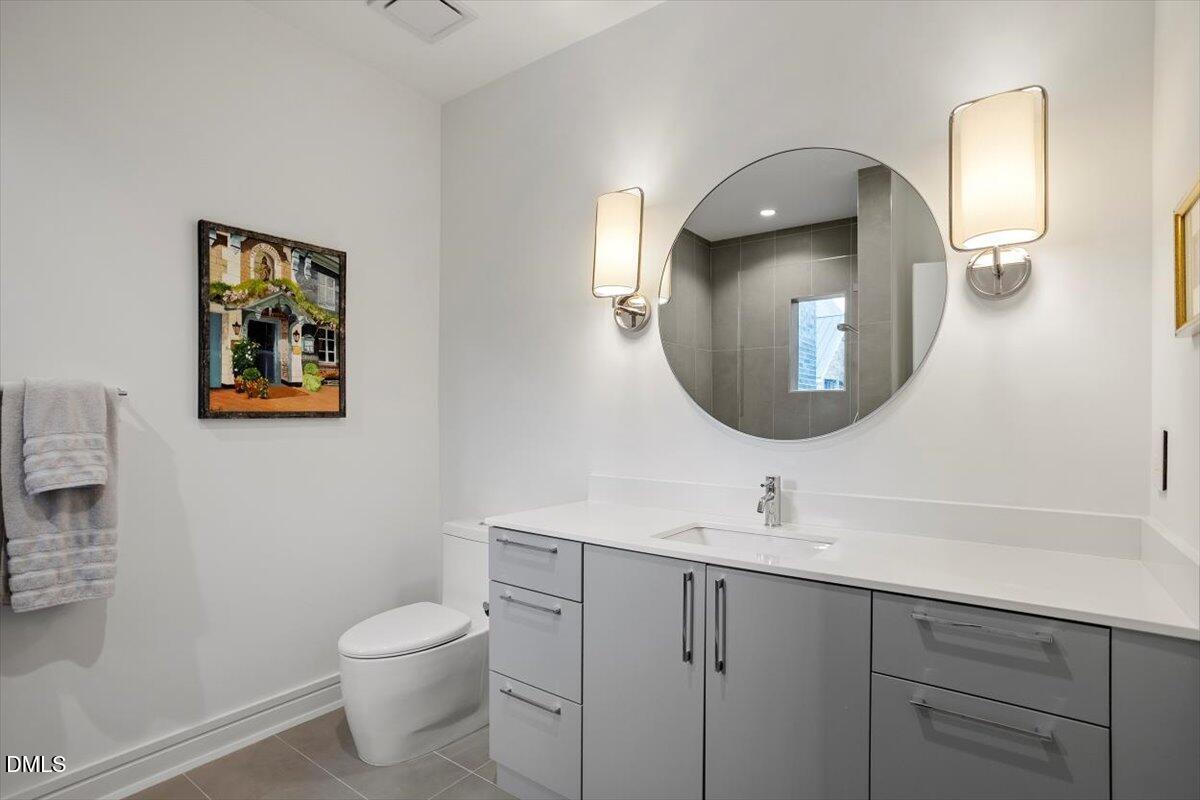 206 Dundas Lane Raleigh, NC 27603 - Photo 23 of 30 a bathroom with a toilet sink and mirror