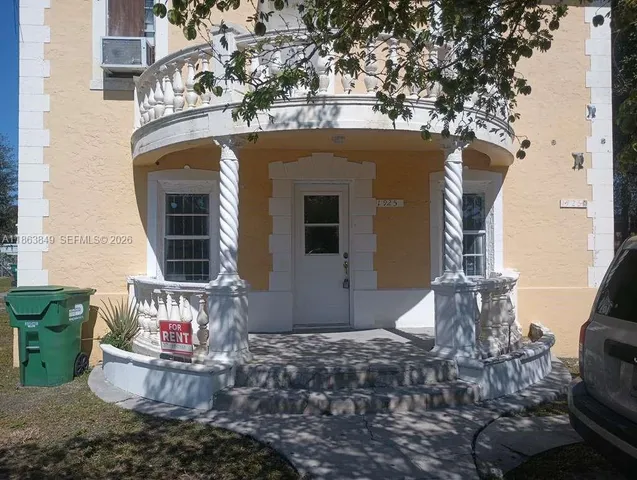 a front view of a house with outdoor seating