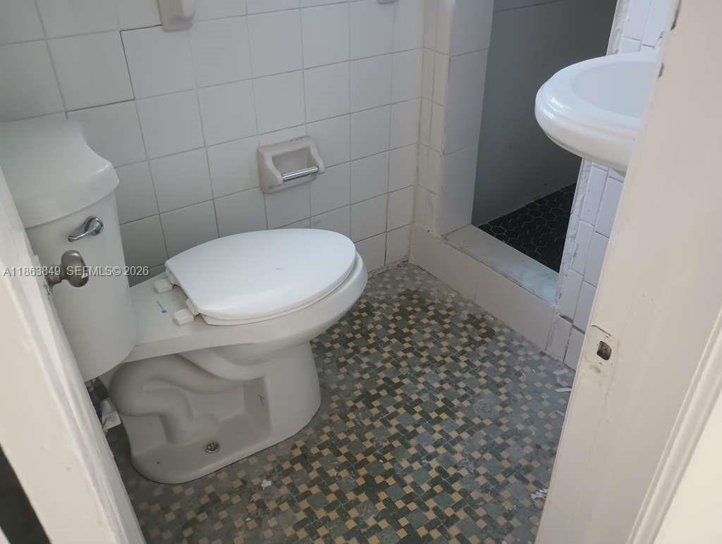 1925 Northwest 56th Street Miami, FL 33142 - Photo 25 of 27 a bathroom with a toilet and a shower