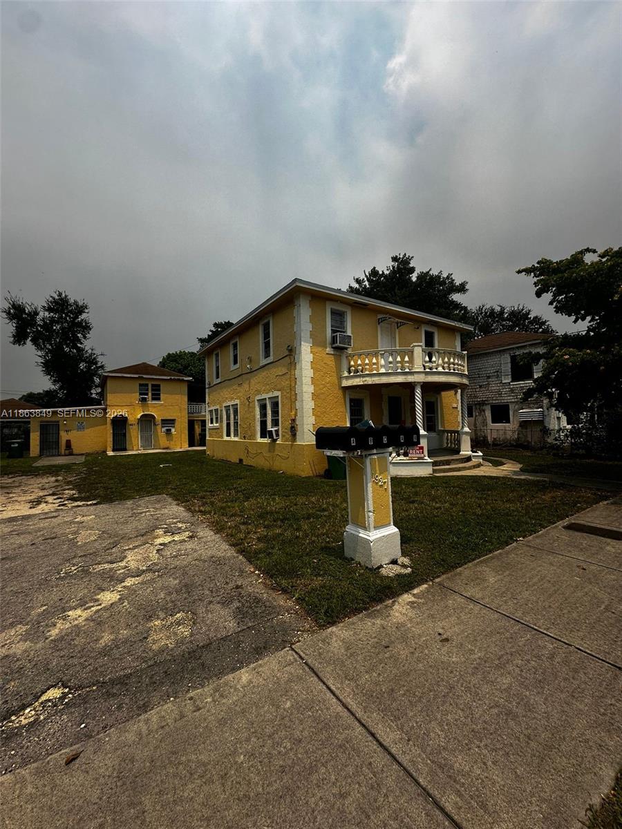 1925 Northwest 56th Street Miami, FL 33142 - Photo 3 of 27 a front view of a house with a yard