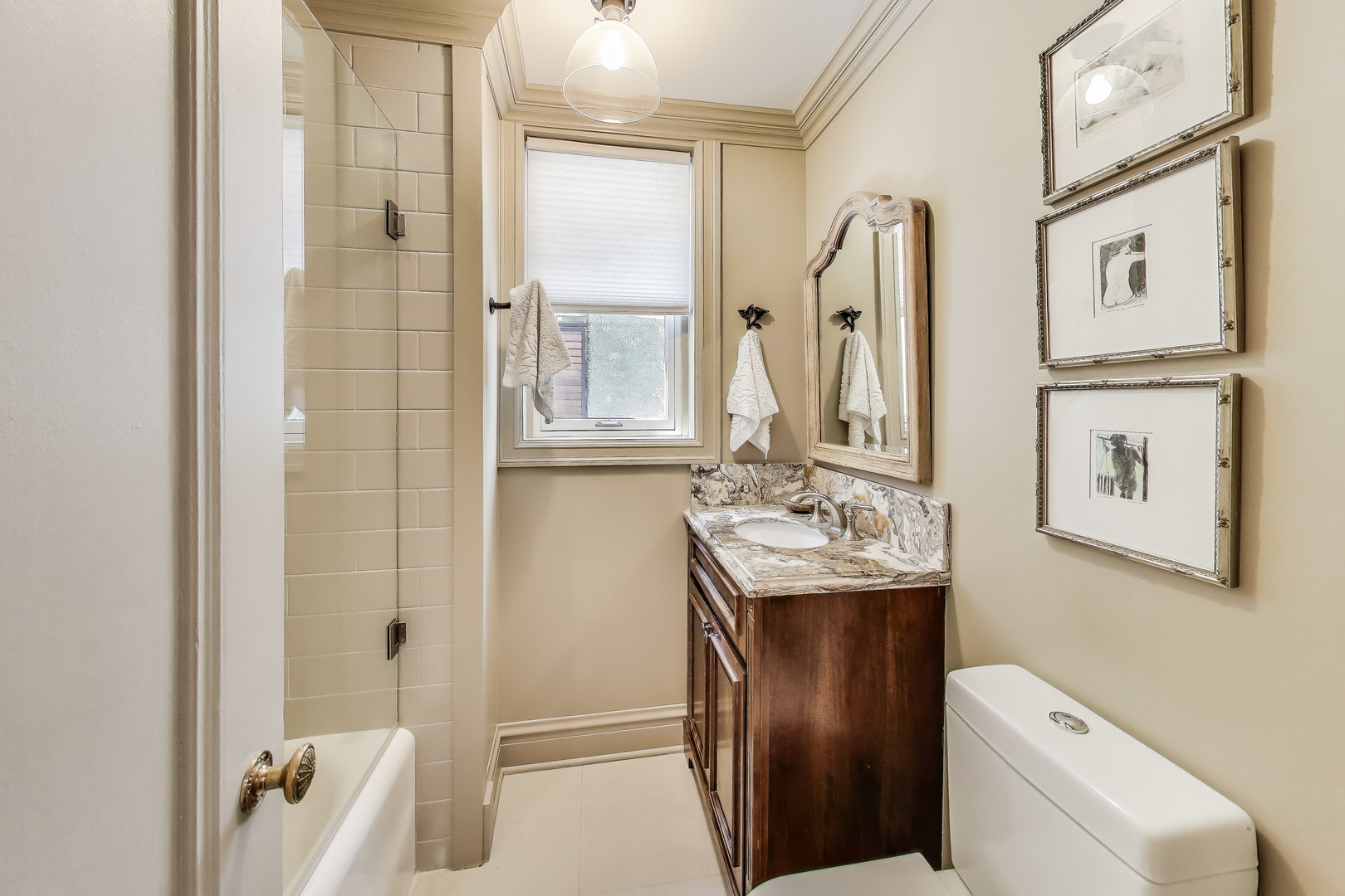 1255 North State Parkway, Unit 2E3E Chicago, IL 60610 - Photo 16 of 38 a bathroom with a sink a toilet and shower