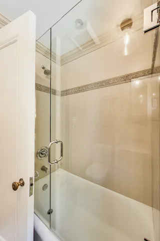 a bathroom with a shower and a shower