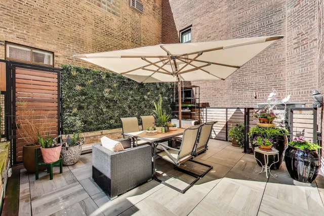 a view of a patio with a table and chairs