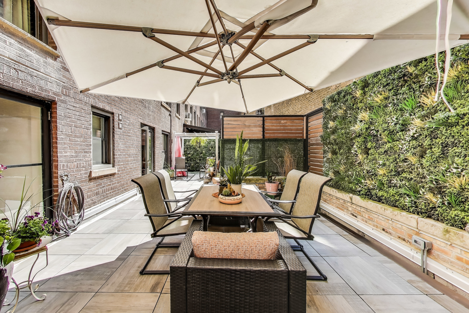 1255 North State Parkway, Unit 2E3E Chicago, IL 60610 - Photo 29 of 38 a view of a patio with a table and chairs under an umbrella