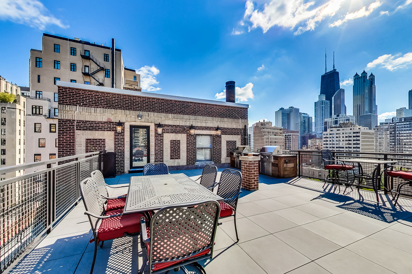 1255 North State Parkway, Unit 2E3E Chicago, IL 60610 - Photo 32 of 38 a view of a patio with couches table and chairs and wooden floor