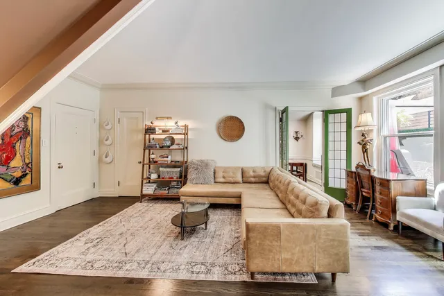 a living room with furniture and wooden floor