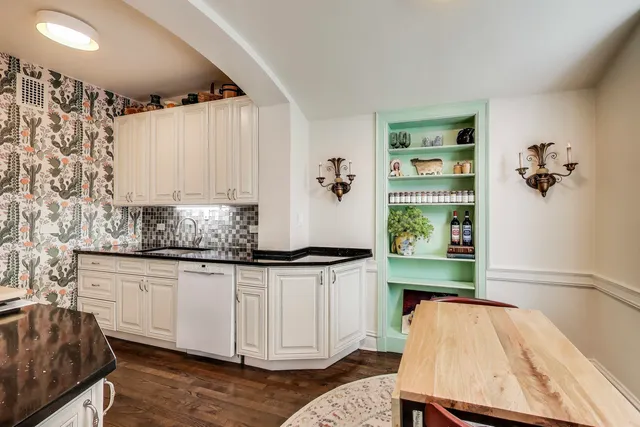 a kitchen with granite countertop a stove and cabinets