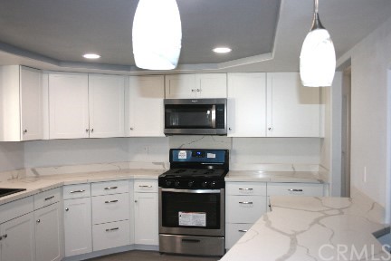 1350 Cabrillo Drive Hemet, CA 92543 - Photo 7 of 30 a kitchen with white cabinets and appliances