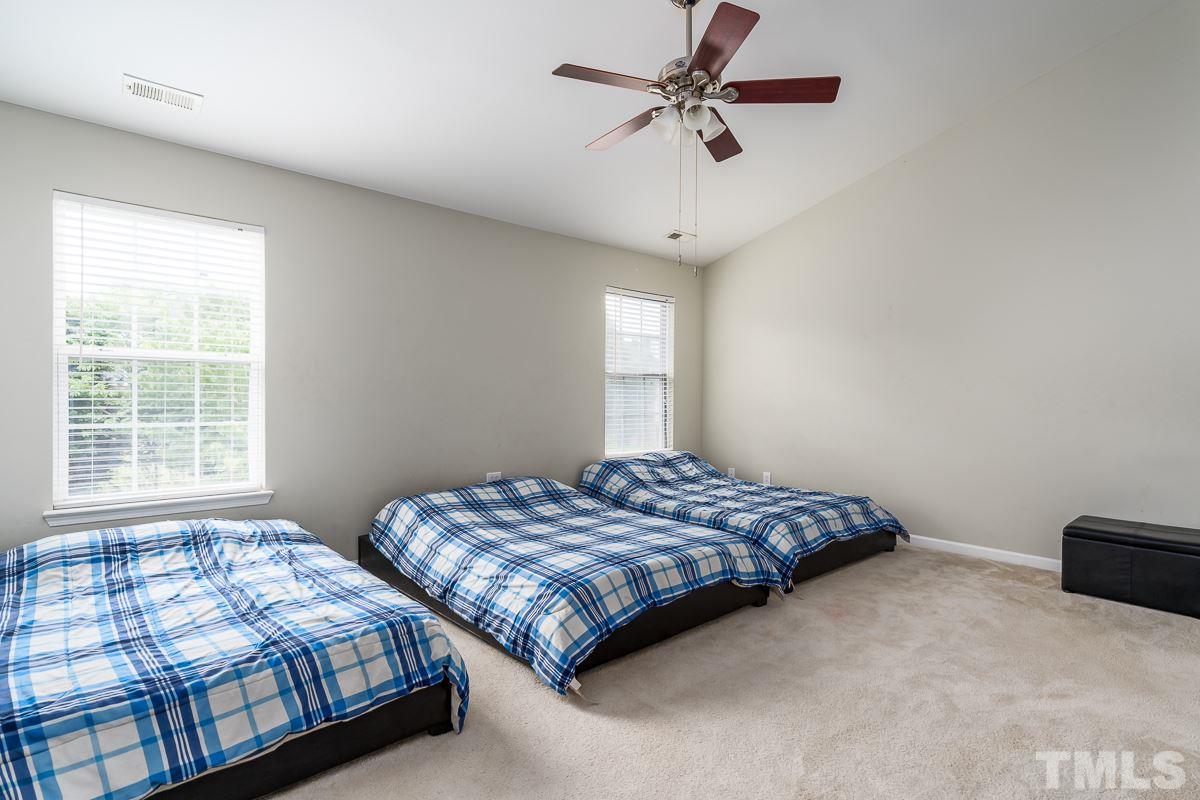 3612 Weir Way Raleigh, NC 27616 - Photo 11 of 19 a bedroom with two beds and a chandelier