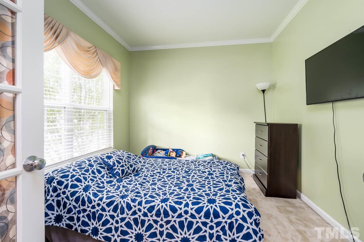 3612 Weir Way Raleigh, NC 27616 - Photo 14 of 19 a bedroom with a bed and a flat screen tv