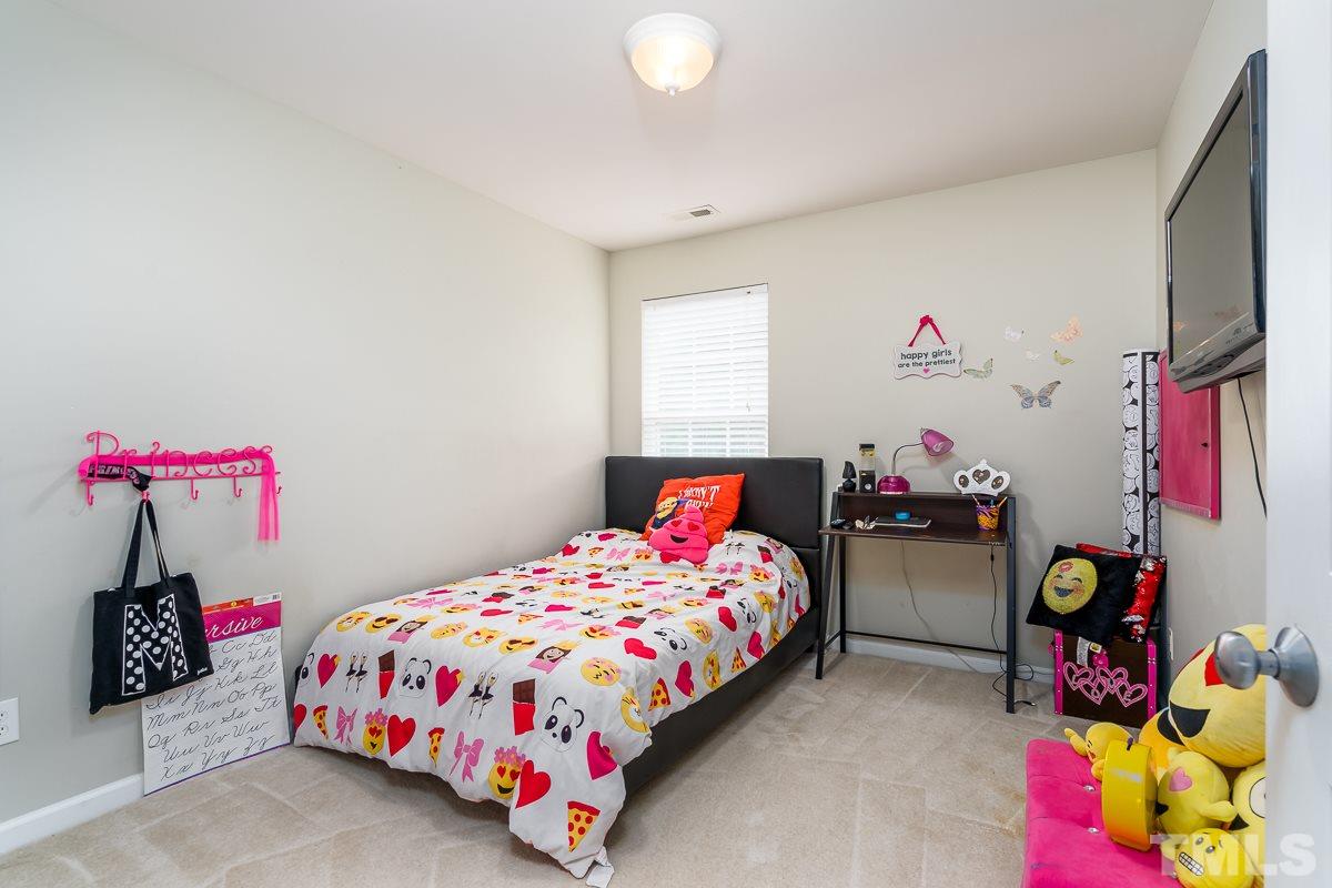 3612 Weir Way Raleigh, NC 27616 - Photo 15 of 19 a bedroom with bed and a bed