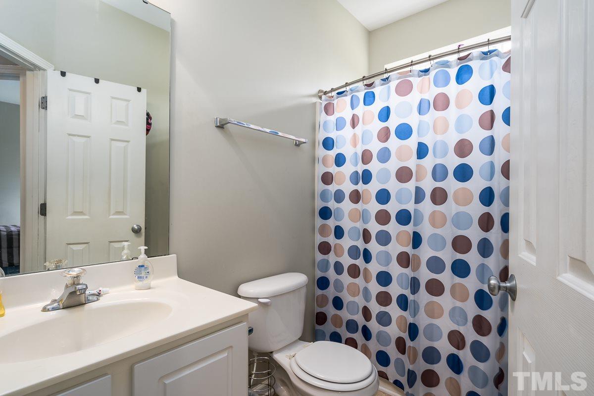 3612 Weir Way Raleigh, NC 27616 - Photo 16 of 19 a bathroom with a sink toilet a shower and a mirror