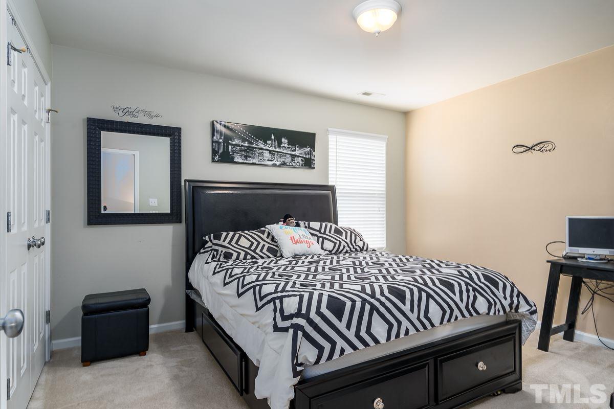 3612 Weir Way Raleigh, NC 27616 - Photo 17 of 19 a bedroom with a bed and wooden floor