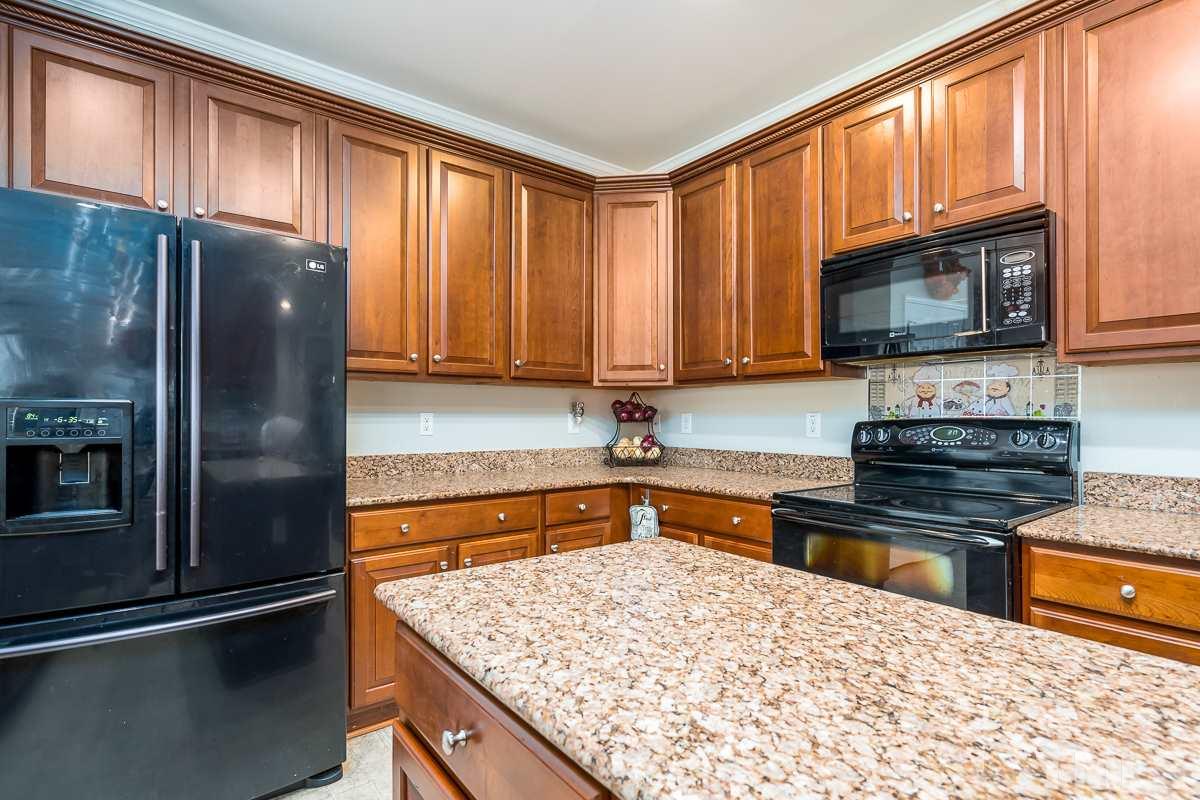 3612 Weir Way Raleigh, NC 27616 - Photo 7 of 19 a kitchen with stainless steel appliances granite countertop a refrigerator stove top oven and sink