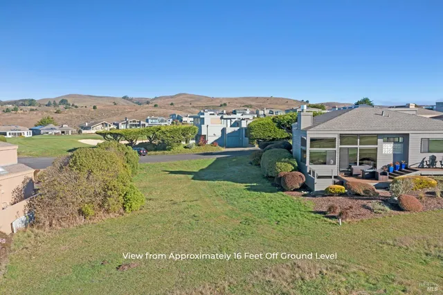 a view of a house with a yard and sitting area