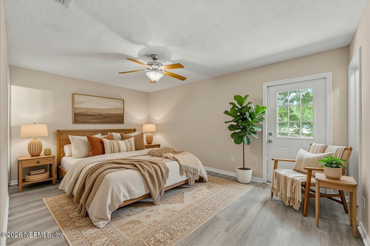 4527 Clairmont Road Jacksonville, FL 32207 - Photo 17 of 40 a bedroom with a bed and a chandelier