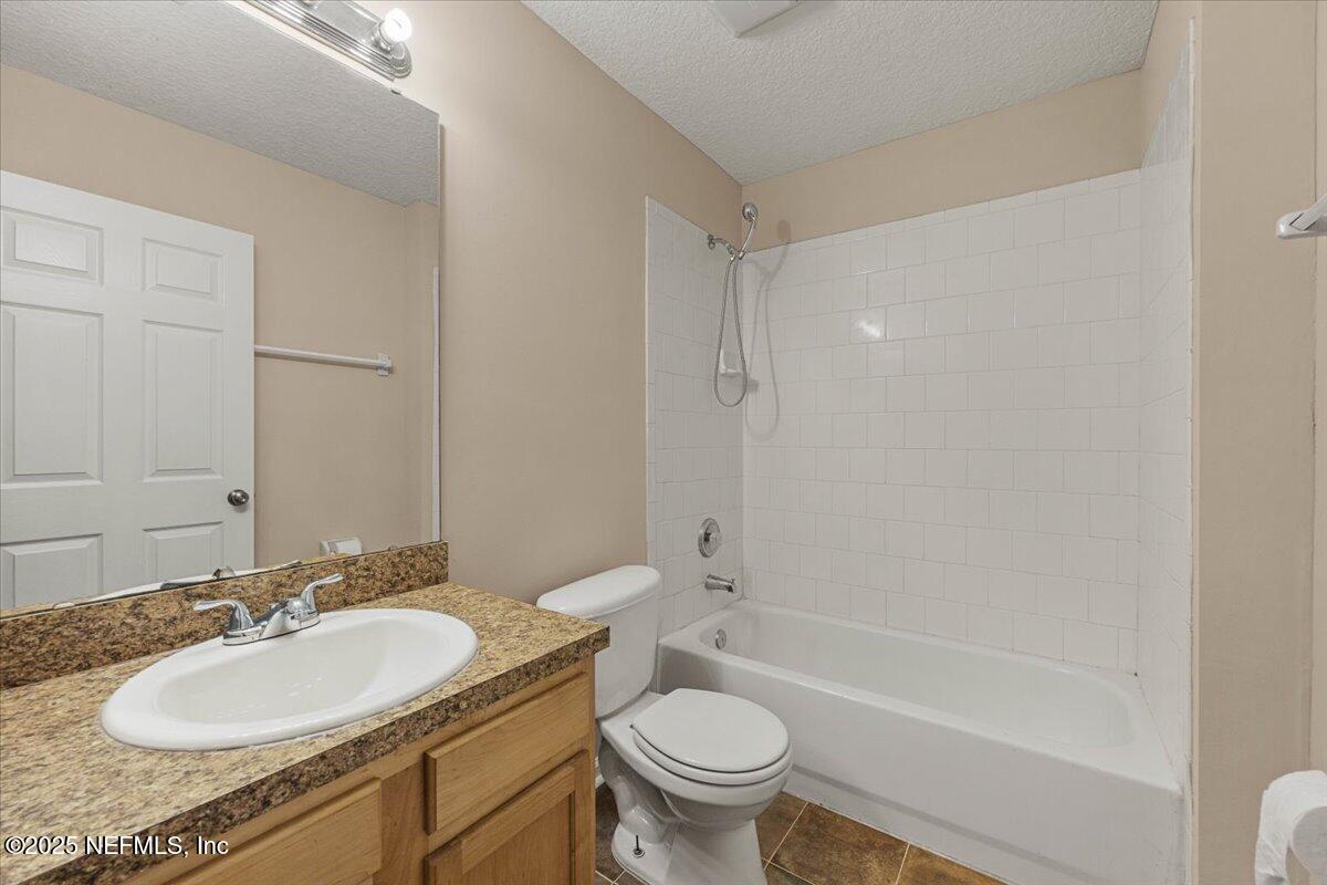 4527 Clairmont Road Jacksonville, FL 32207 - Photo 24 of 40 a bathroom with a sink toilet a mirror and shower
