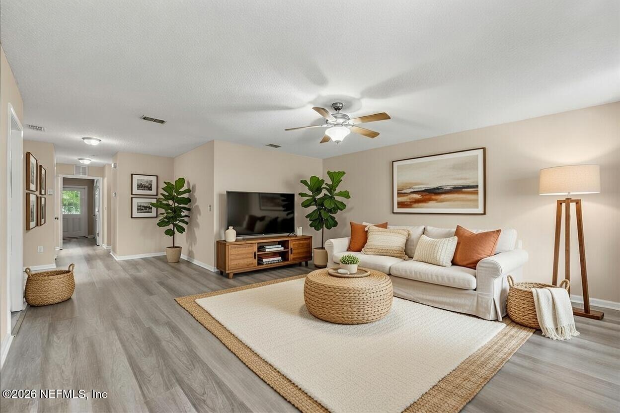 4527 Clairmont Road Jacksonville, FL 32207 - Photo 6 of 40 a living room with furniture a flat screen tv and a fireplace