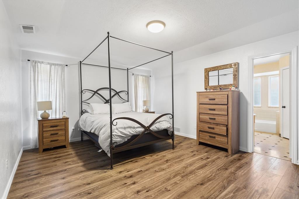 2214 Valley Mill Carrollton, TX 75006 - Photo 20 of 36 a bedroom with a bed and a closet