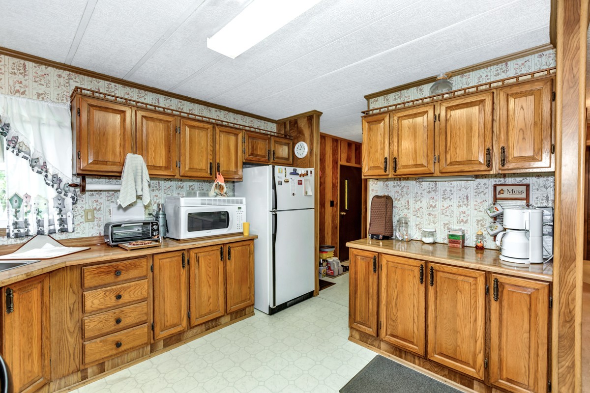 272 Jones Road Taft, TN 38488 - Photo 11 of 40 a kitchen with stainless steel appliances a refrigerator sink and cabinets