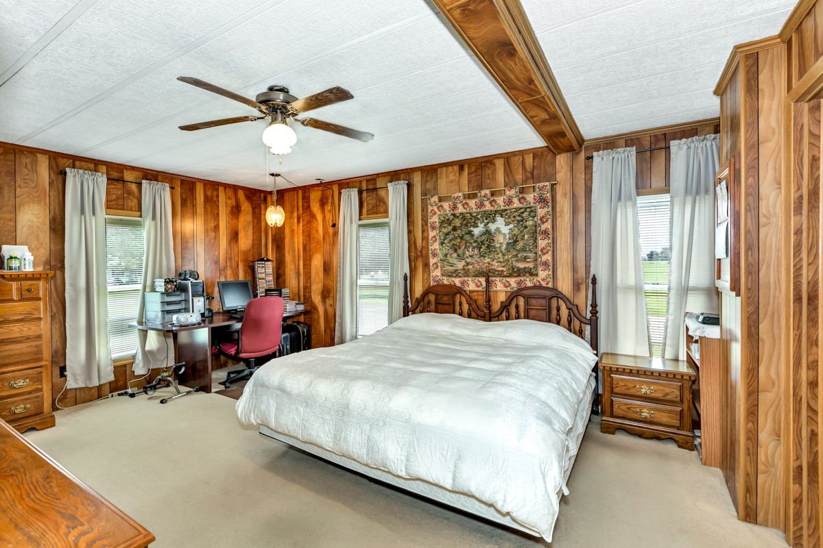 272 Jones Road Taft, TN 38488 - Photo 14 of 40 a bedroom with a bed and large windows