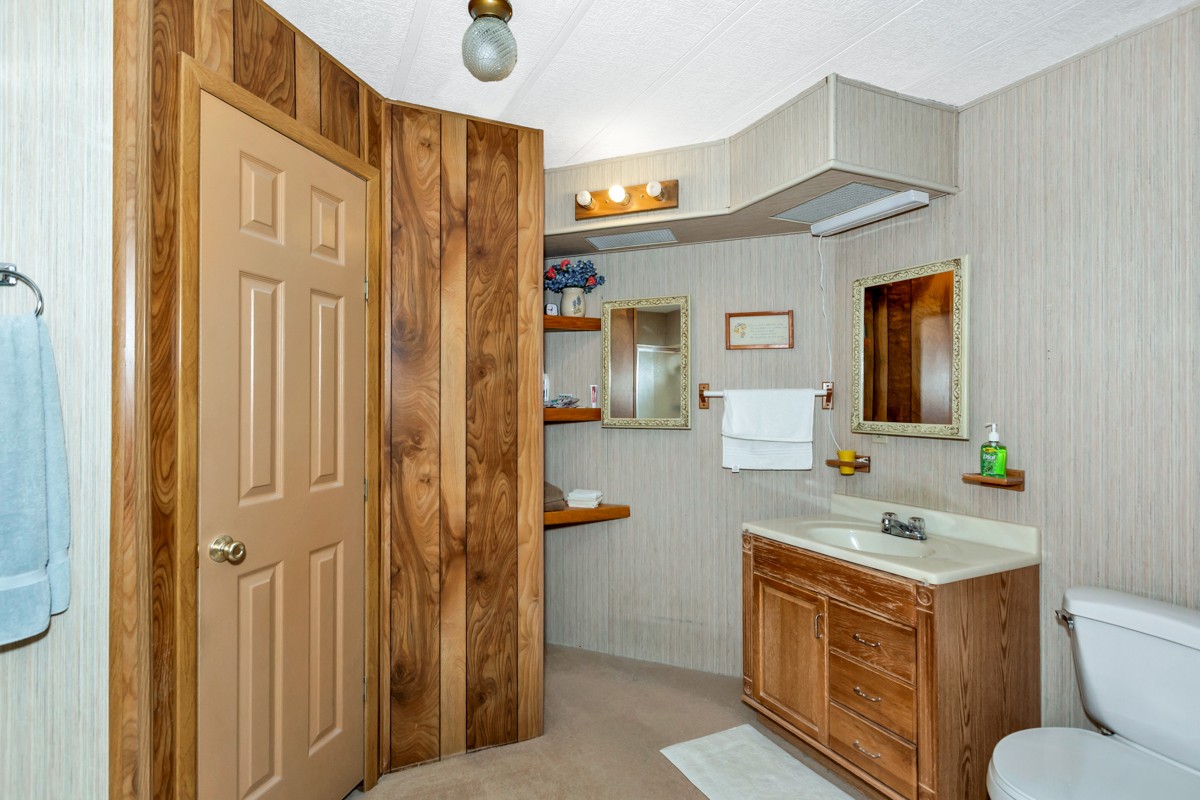 272 Jones Road Taft, TN 38488 - Photo 16 of 40 a bathroom with a granite countertop sink toilet and mirror