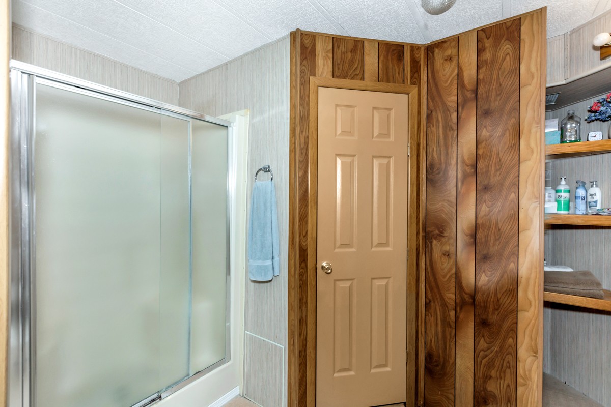 272 Jones Road Taft, TN 38488 - Photo 17 of 40 a bathroom with a shower and a glass door