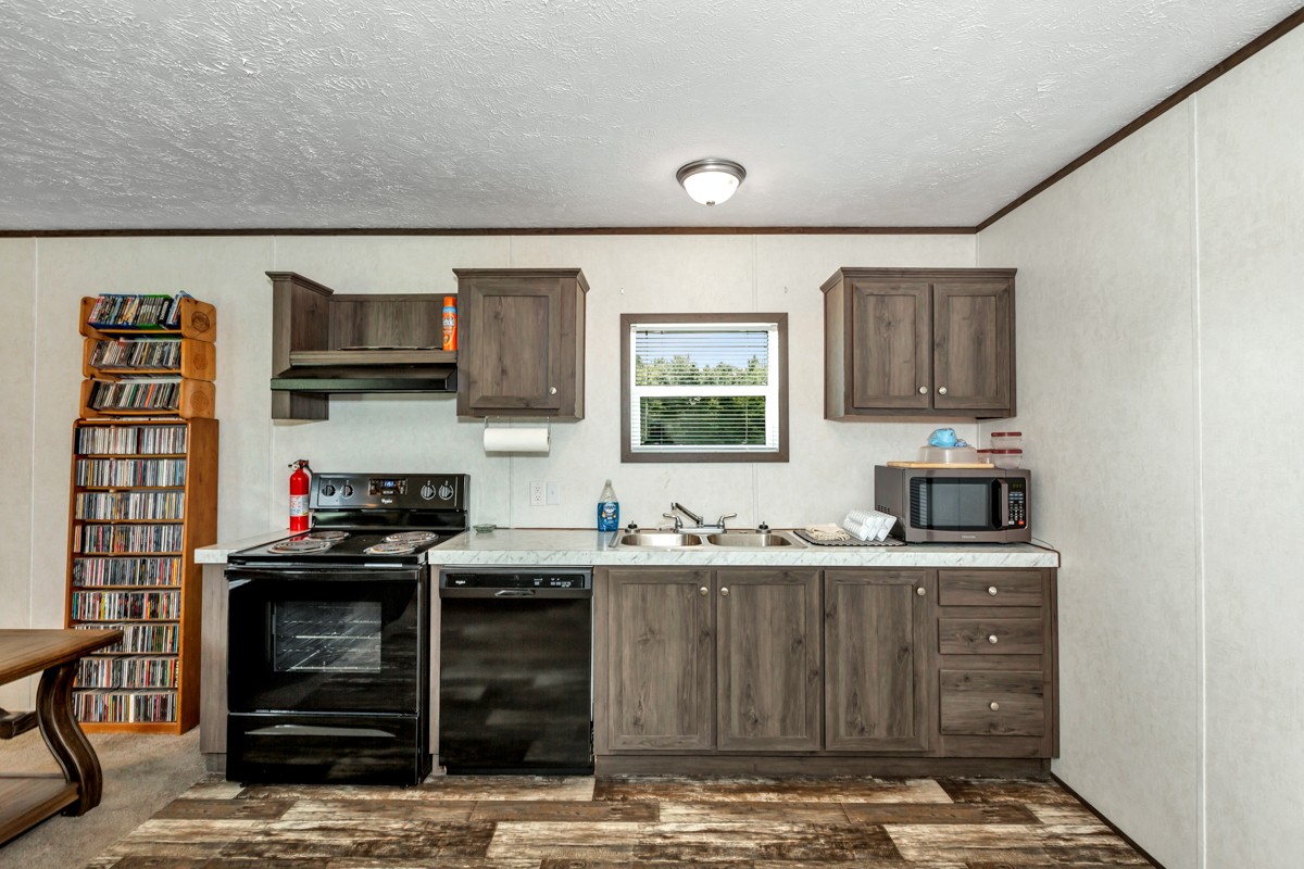 272 Jones Road Taft, TN 38488 - Photo 26 of 40 a kitchen with stainless steel appliances granite countertop a stove and a sink