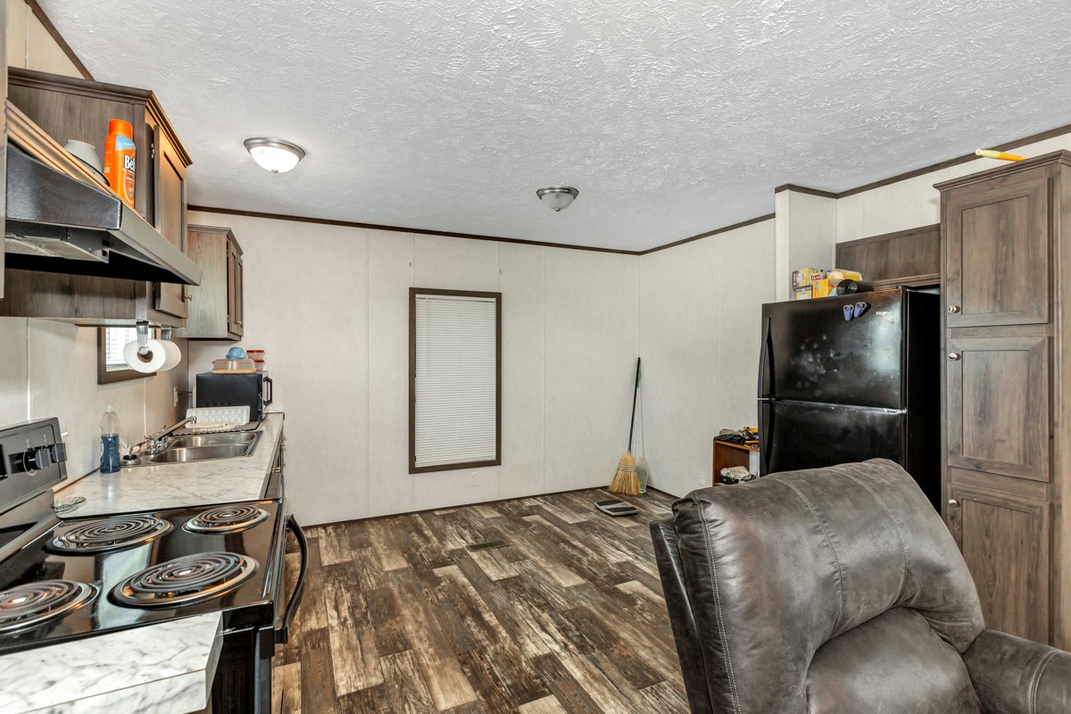 272 Jones Road Taft, TN 38488 - Photo 27 of 40 a bedroom with a bed and a refrigerator