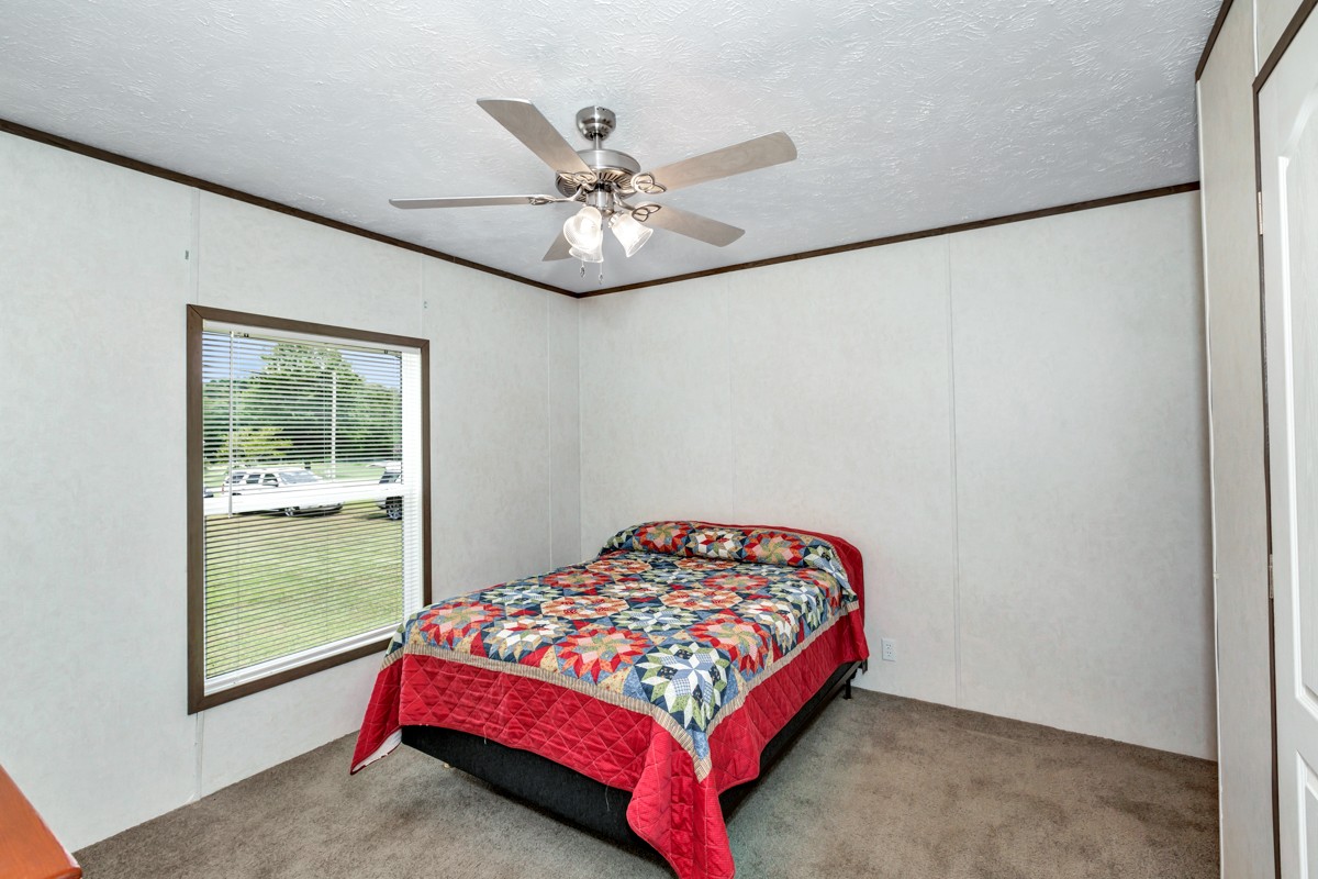 272 Jones Road Taft, TN 38488 - Photo 28 of 40 a bedroom with a bed and window