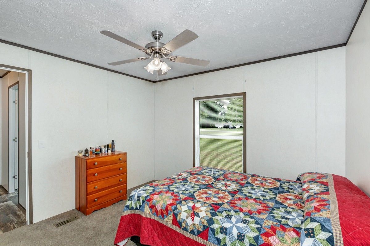272 Jones Road Taft, TN 38488 - Photo 29 of 40 a bedroom with a bed and a chandelier