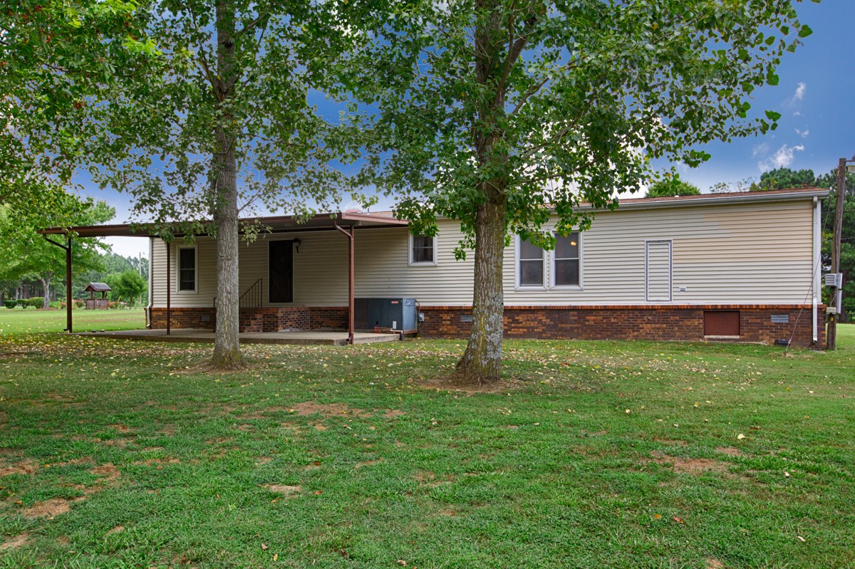 272 Jones Road Taft, TN 38488 - Photo 4 of 40 a backyard of a house with barbeque oven and large trees