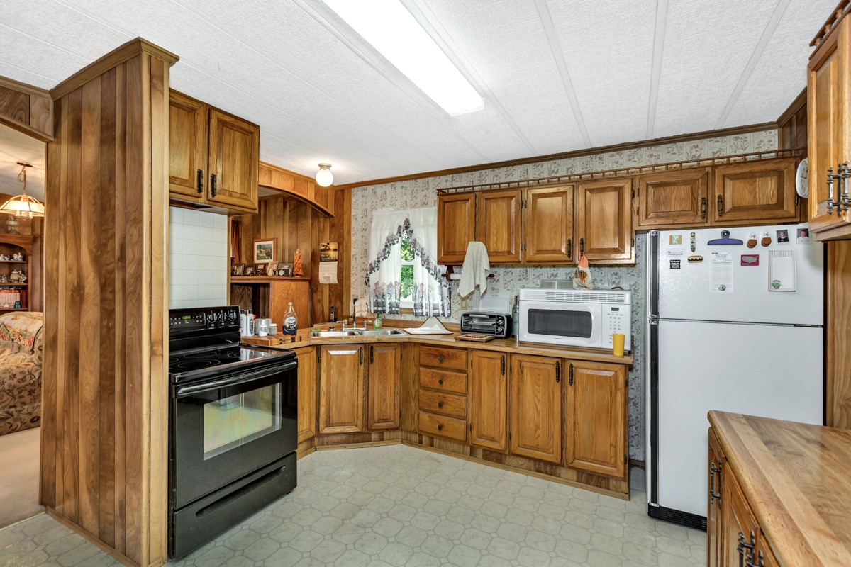 272 Jones Road Taft, TN 38488 - Photo 9 of 40 a kitchen with stainless steel appliances granite countertop a refrigerator stove and sink