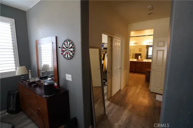 a living room with furniture and a mirror next to a window