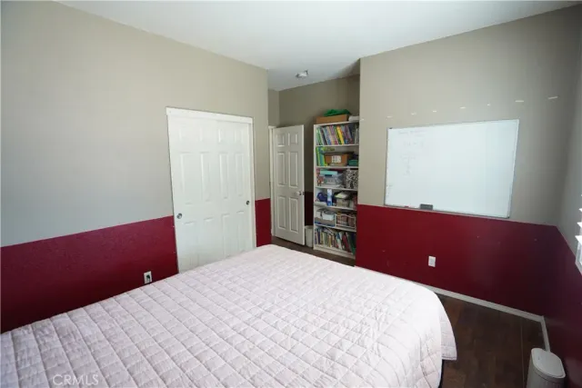 a bedroom with a bed and a book shelf