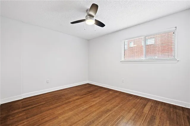 a view of room with hardwood floor and window