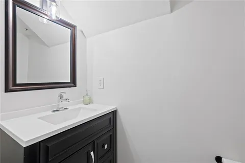 a bathroom with a sink vanity and a mirror