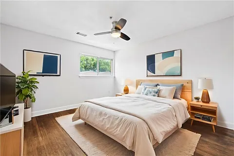 a bedroom with a bed and a wooden floor