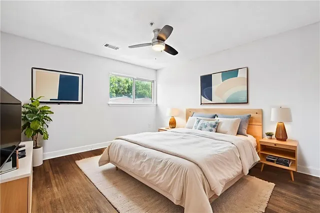 a bedroom with a bed and a wooden floor