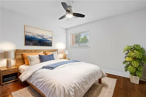 a bedroom with bed and a potted plant